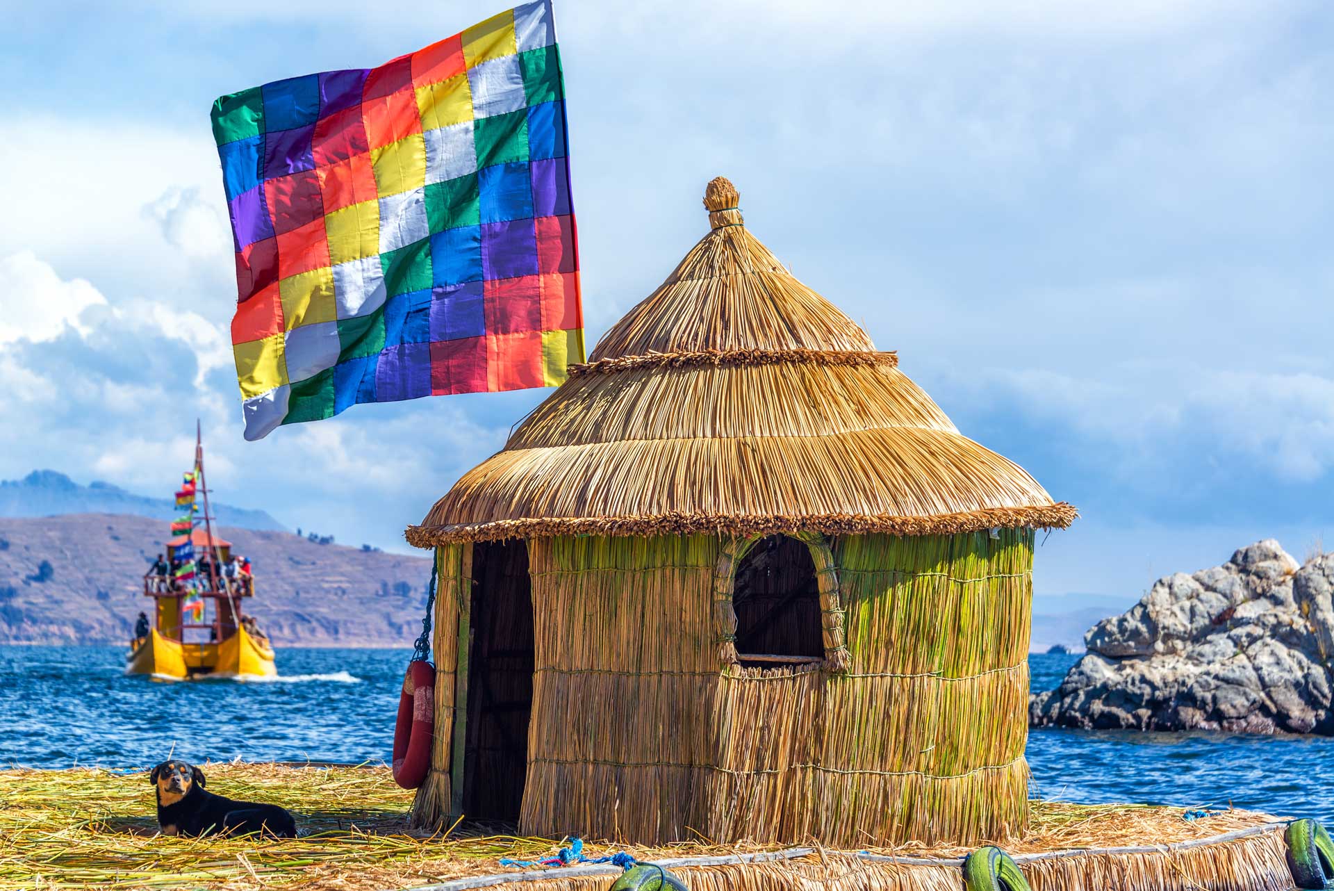 Whiphala flag on a hut on a floating island on Lake Titicaca near Copacabana, Bolivia